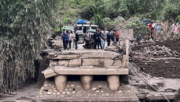 جسر هيوا خولا المتضرر قرب نهر هيوا الذي فاض بعد هطول أمطار غزيرة في بانتشثار (18 حزيران 2023ـ أ ف ب).