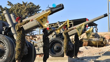 عناصر لـ"حزب الله" أمام آليات عسكرية في بعلبك (حسام شبارو).