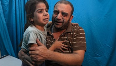 فلسطينيون جرحى جرّاء القصف الإسرائيلي على المستشفى المعمداني في غزّة (أ ف ب).