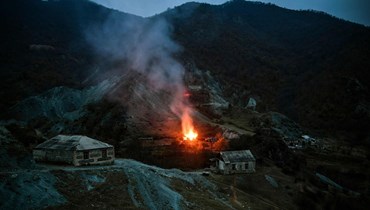 منزل يحترق في قرية خارج بلدة كلبجار، بعد توقيع اتفاق سلام لإنهاء النزاع العسكري بين أرمينيا وأذربيجان حول ناغورني - كراباخ (14 ت2 2020 - أ ف ب).
