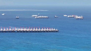 صورة التقطت في 2 كانون الاول 2023 ونشرها خفر السواحل الفيليبينيون في 3 منه، تظهر سفنا صينية تجمعت غرب جزيرة بالاوان (أ ف ب). 