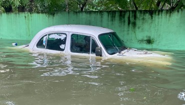 سيّارة في شارع غمرته المياه في الهند جرّاء الأمطار (أ ف ب). 