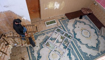 رجل يتفقد الأضرار التي لحقت بمنزل بعد ضربة صاروخية شنها الحرس الثوري الإيراني على عاصمة إقليم كردستان أربيل (16 كانون الثاني 2024- أ ف ب).