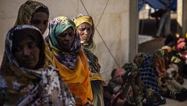 لاجئون سودانيون فروا من الحرب في السودان، يصطفون خلال برنامج المساعدة النقدية في مركز عبور للاجئين في الرنك (15 شباط 2024ـ أ ف ب). 