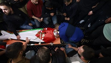 فلسطينيون يشيعون، في قرية بيتين بالقرب من رام الله بالضفة الغربية، جثمان عمر حامد، الذي قُتل خلال اشتباكات مع مستوطنين إسرائيليين (14 نيسان 2024، أ ف ب). 