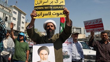 تظاهرة مناهضة لإسرائيل بعد صلاة ظهر الجمعة في طهران (19 نيسان 2024، أ ف ب). 